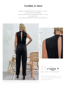 Detail view of the backless design and elastic waist on this black V-neck jumpsuit