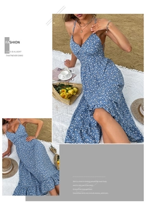 Detailed view of blue floral sundress with ruffle hem on a beach picnic setting