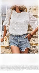 Detail of white chiffon top featuring 3D flocked polka dots and ruffle sleeves