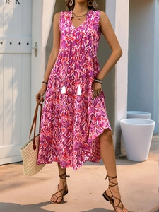 Detail of pink leopard print boho dress with V-neckline and white tassel drawstrings