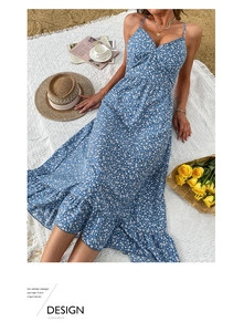 Detail of navy floral sundress with tiered ruffles on a beach picnic setting
