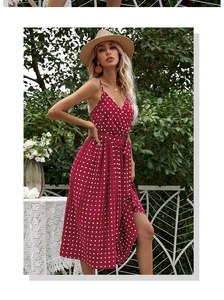 Detailed view of red polka dot midi dress featuring waist tie and pleated skirt