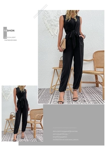 Detail of black sleeveless jumpsuit showing drawstring waist and tapered leg cuffs
