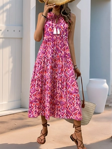 Detail of pink floral bohemian dress featuring a tassel drawstring and layered hem