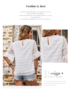 Detail of white chiffon blouse featuring Swiss dot texture and ruffle sleeve design