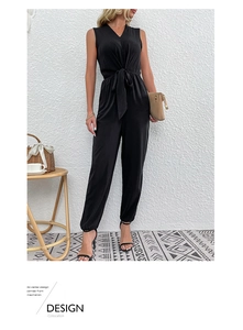 Detail of elegant black sleeveless V-neck jumpsuit with waist tie and slim-fit trousers