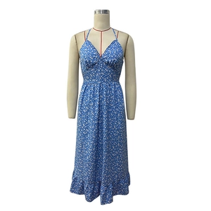 Close-up of blue floral halter dress featuring V-neckline and ruffled hem detail
