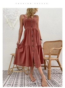 Detail of terracotta cotton linen tiered dress with buttons and backless bohemian style