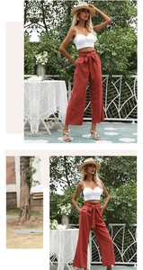 Détail du pantalon large taille haute avec ceinture à nœud en tissu respirant rouge brique