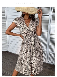 Close-up of the elegant deep V-neckline and tie-waist detail on the summer leopard dress