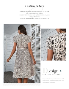 Detail of short puff sleeves and pleated hem on black and white polka dot summer dress