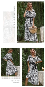 Close-up of V-neck floral midi dress with palm print and elegant waist belt detail