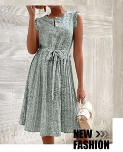 Detail of green floral sleeveless dress showing the waist tie and pleated skirt design
