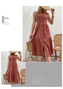 Close-up of the cotton linen sundress featuring a button-down front and tiered hem detail
