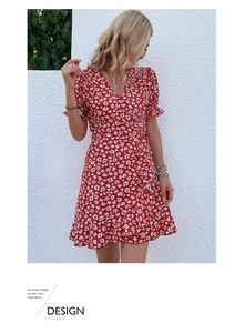 Detailed close-up of a red floral wrap dress with ruffle sleeves and waist tie design