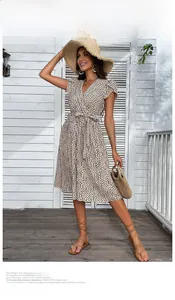 Detail of V-neck wrap dress with leopard print and ruffled sleeves on model