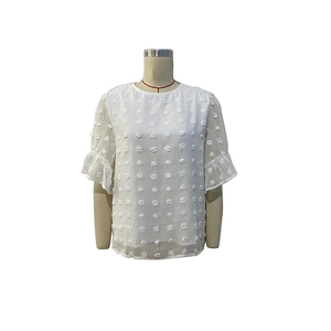 Detail of white chiffon top featuring 3D pom-pom texture and ruffled flutter sleeves