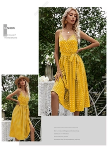 Detail view of yellow polka dot V-neck midi dress with belted waist and pleated skirt