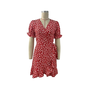 Detailed close-up of the red floral wrap dress featuring ruffles and a delicate V-neckline
