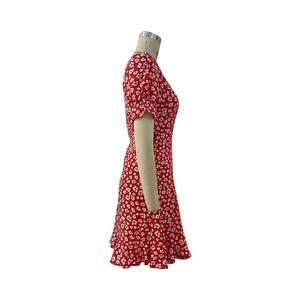 Detailed view of red floral summer dress with ruffle sleeves and slim fit waistline