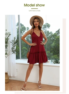 Detail of wine red halter dress featuring a deep V-neckline and ruffled hemline