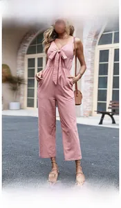 Detail of high waist wide leg jumpsuit with V-neck knot front and linen texture
