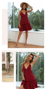 Detailed close-up of dark red halter dress with deep V-neck and ruffled hem details