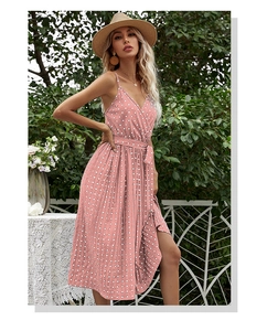 Detail showing the pink polka dot summer dress with V-neckline and waist tie detail