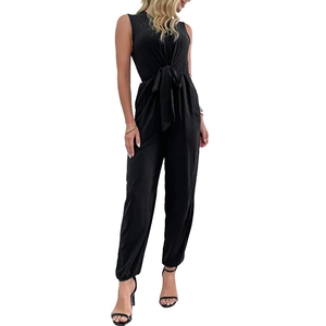 Sleeveless black V-neck jumpsuit with waist tie and cuffed ankles on white background