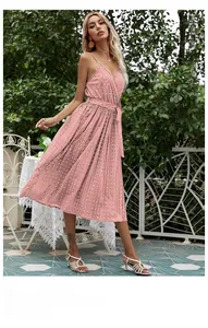 Detail of pink polka dot chiffon dress with V-neck, waist tie and pleated skirt