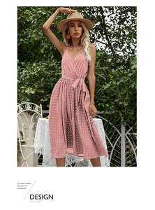Detailed view of pink polka dot sundress featuring V-neck wrap design and waist tie