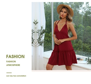 Detail showing deep V-neckline and ruffled hem of the dark red halter neck summer dress
