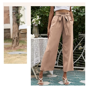 Détail d'un pantalon taille haute paper-bag kaki avec ceinture à nœud assortie