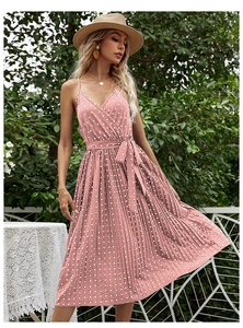 Detailed view of the pink polka dot pleated dress with a V-neck and waist tie design