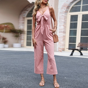 Pink V-neck linen sleeveless jumpsuit with cutout waist and bow detail for summer