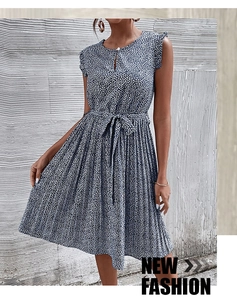 Close-up of sleeveless navy floral dress with pleated hem and waist tie detail