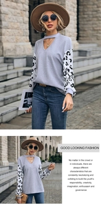 Detail of grey waffle knit top with leopard print patchwork sleeves and hollow V-neckline