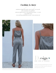 Detail view showing thin straps and elastic high waist of gray sleeveless jumpsuit