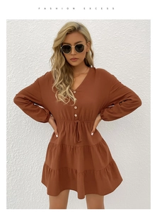 Detail of rust red V-neck mini dress with button front and drawstring waist design