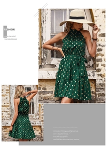 Detail of dark green halter dress with gold polka dots and a backless ruffle design