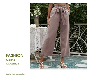 Détail d'un pantalon large à taille haute avec taille élastique à volants et ceinture