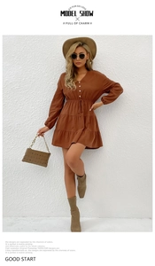 Detail view of brown V-neck mini dress with waist drawstring and button closure