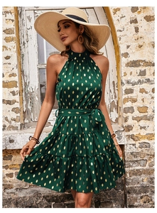 Detail of dark green halter neck dress with gold leaf patterns and layered cake skirt