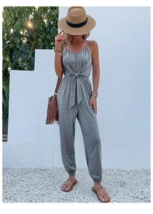Detail of grey waist-tie jumpsuit with spaghetti straps and gathered ankle cuffs