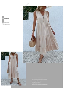 Close-up of sleeveless V-neck beige summer dress with decorative buttons and layered skirt