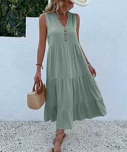 Detail of a sleeveless V-neck sage green maxi dress with buttons and tiered skirt design
