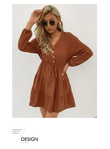 Detail of V-neck buttoned bodice and waist drawstring on a brown long sleeve dress