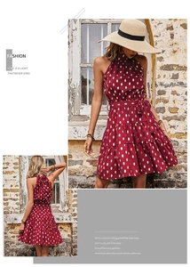 Detailed view of the halter neck tie and layered ruffle hem on burgundy polka dot dress