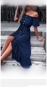 Detail of off-shoulder neckline with ruffle trim and white buttons on navy blue dress