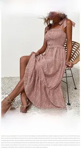 Detail showing the elastic smocked waist and wooden buttons on the floral pink dress